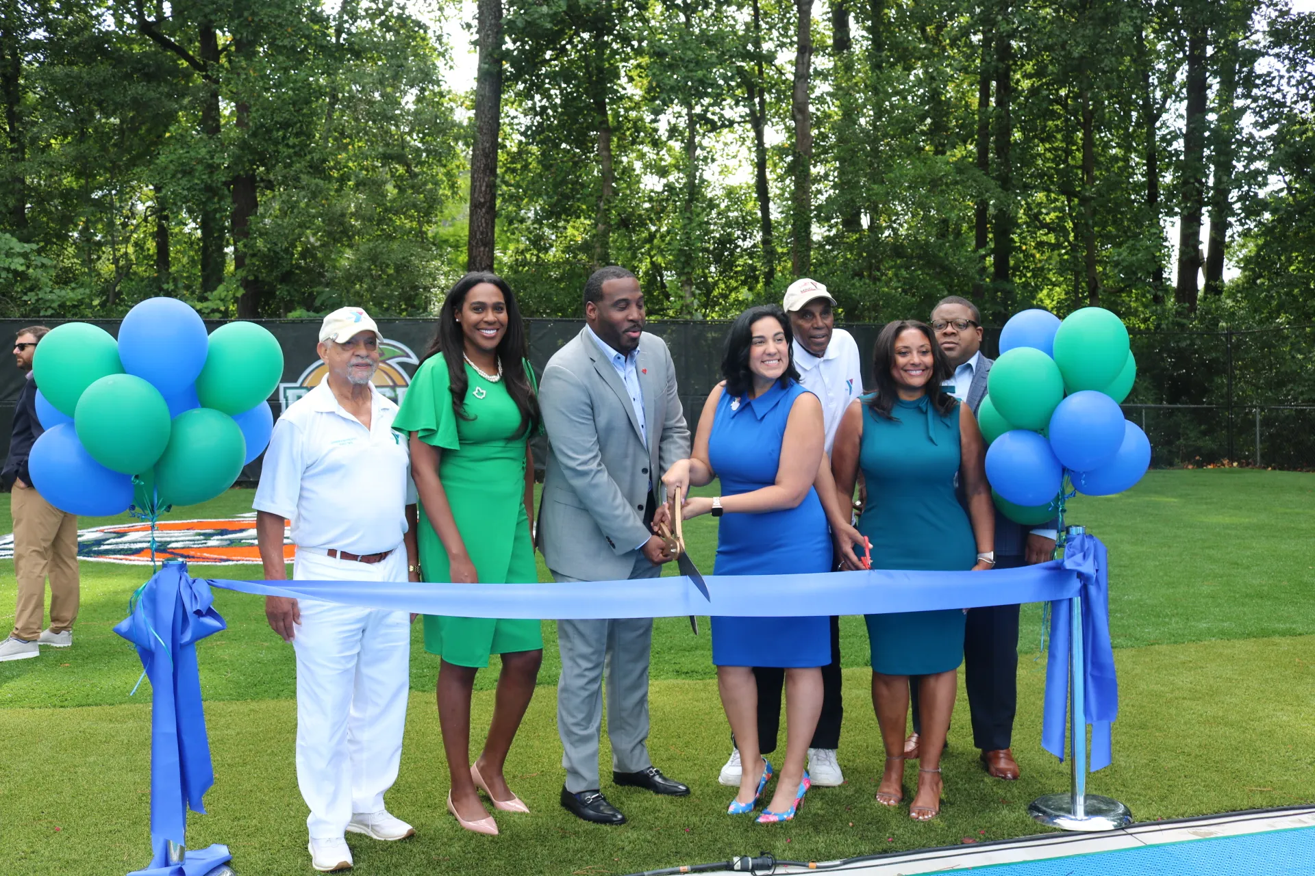 City leaders at Peach Bowl Inc. ribbon-cutting event at Young YMCA