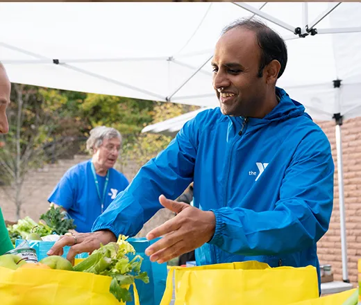 YMCA employee packing food for community outreach