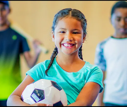 Children holding various sports equipment