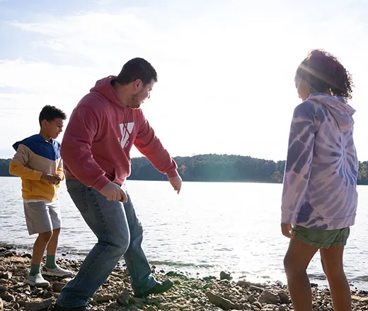 Kids skipping rocks