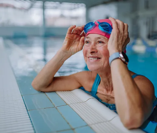 senior woman swimmer on side of pool
