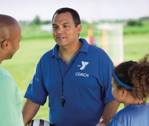 coach talking to player and parent