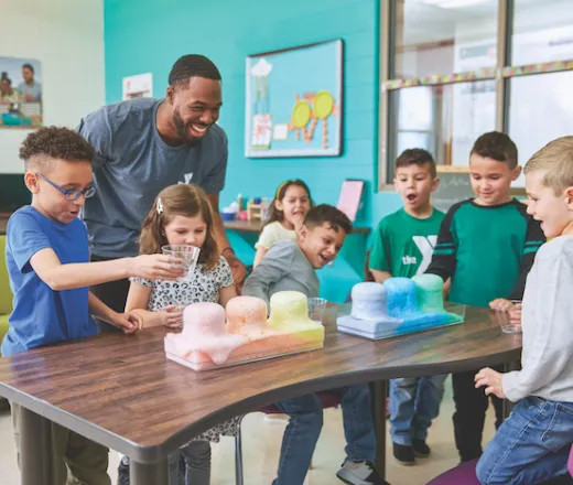 Y explore instructor looking over an experiment with Y explore participants